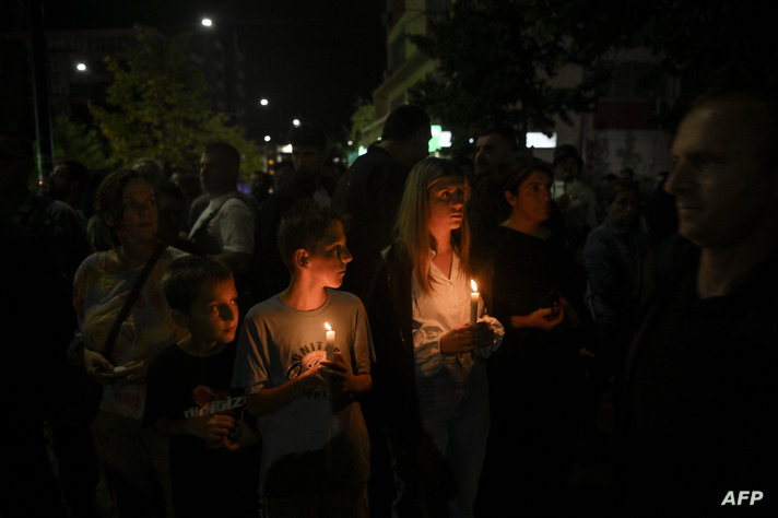 People light candles in front of the police station in memory of the Kosovo Police officer Afrim Bunjaku, who was killed by…