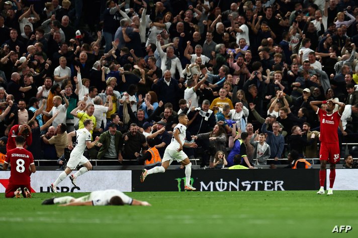 Tottenham Hotspur's players celebrate following the own goal scored by Liverpool's German-born Cameroonian defender #32 Joel…