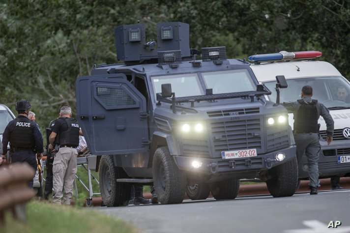 Kosovo police officers evacuate a wounded person at a cross road leading to the Banjska Monastery in the village of Banjska on…