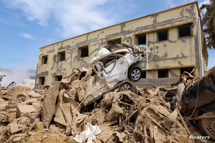 Destroyed car sits on top of a pile of rubble, following fatal floods in Derna