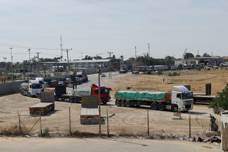 Trucks carrying aid wait to exit, on the Palestinian side of the border with Egypt, as the conflict between Israel and Palestinian Islamist group Hamas continues, in Rafah in the southern Gaza Strip, October 21, 2023. REUTERS/Ibraheem Abu Mustafa TPX IMAGES OF THE DAY