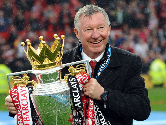 Manchester United's Scottish manager Alex Ferguson kisses the Premier League trophy at the end of the English Premier League football match between Manchester United and Swansea City at Old Trafford in Manchester, northwest England, on May 12, 2013. Ferguson said farewell to Old Trafford with a typically passionate speech after his side's 2-1 victory over Swansea in his final home match in charge of the team. AFP PHOTO / ANDREW YATES