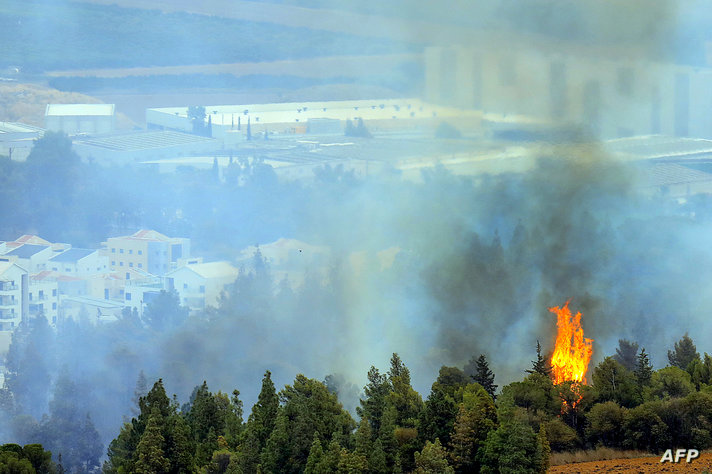 A picture taken from southern Lebanon near the border with Israel shows smoke rising near the northern Israeli Kibbutz of Kfar…