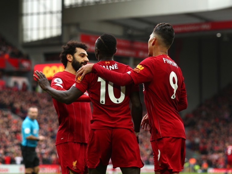 LIVERPOOL, ENGLAND - MARCH 07: Sadio Mane of Liverpool celebrates with Mohamed Salah and Roberto Firmino after scoring his team's second goal during the Premier League match between Liverpool FC and AFC Bournemouth at Anfield on March 07, 2020 in Liverpool, United Kingdom. (Photo by Jan Kruger/Getty Images)