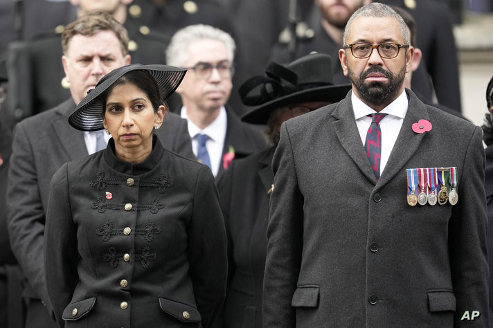 FILE - Britain's Home Secretary Suella Braverman stands with Foreign Secretary James Cleverly as they attend the Remembrance…