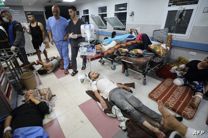 EDITORS NOTE: Graphic content / Wounded Palestinians receive treatment at the Al-Shifa hospital in Gaza City on November 7,…