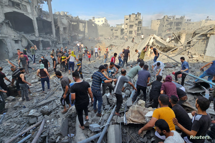 Palestinians search for casualties at the site of Israeli strikes on houses in Jabalia refugee camp