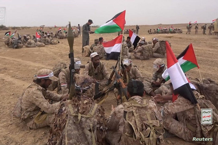 Houthi fighters gather during a military manoeuvre near Sanaa