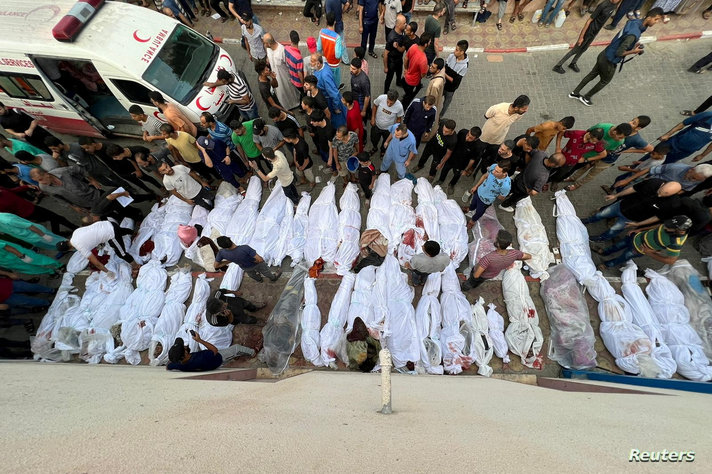 Bodies of Palestinians killed in Israeli strikes on houses in Jabalia refugee camp, lie at a hospital in the northern Gaza Strip