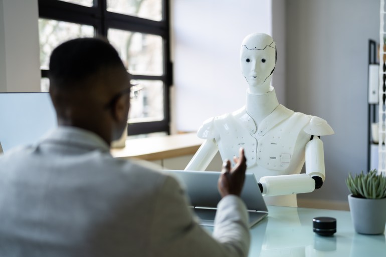 African Men At Interview With AI Robot Machine