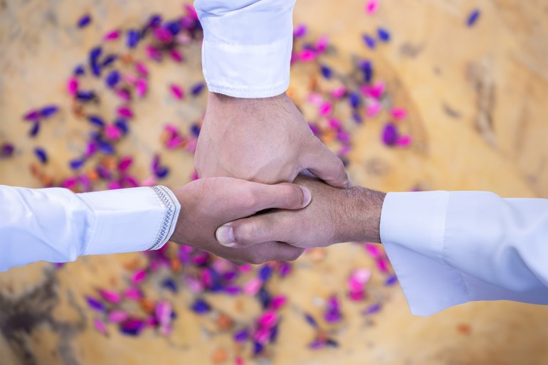 multigender arabic people join their hands together represents agreement for their deal