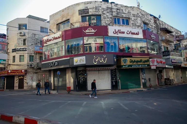 In Nablus, Palestinians walk by closed shops in December, during a global day of boycotts and strikes calling for a ceasefire in Gaza [by Nasser Ishtayeh/SOPA Images/LightRocket via Getty Images]