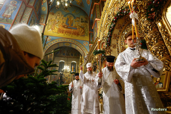 Ukrainian believers attend a Christmas Eve service in Kyiv