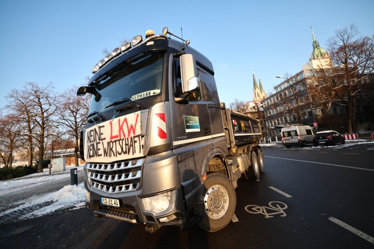 epa11071041 A banner reads 'no trucks, no economy', on a truck arriving for a farmers and truckers protest at the Theresienwiese in Munich, Germany, 12 January 2024. German farmers have kicked off a week of nationwide protests with highway blockades and demonstrations, in response to the government plans to phase out agricultural diesel subsidies. EPA-EFE/ANNA SZILAGYI