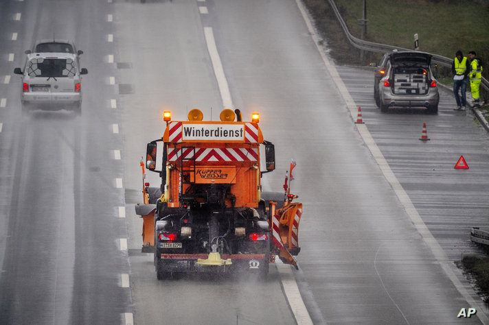 A salt truck drives on a highway as rain sets in combined with low temperatures in Frankfurt, Germany, Wednesday, Jan. 17, 2024…