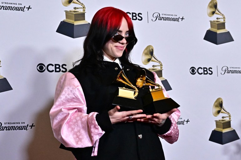 US singer-songwriter Billie Eilish poses in the press room with the Grammys for Song of the Year and Best Song Written Visual Media for "What Was I Made For?" during the 66th Annual Grammy Awards at the Crypto.com Arena in Los Angeles on February 4, 2024. (Photo by Frederic J. Brown / AFP)