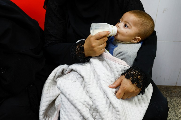 A Palestinian boy is bottle-fed at Abu Yousef al-Najjar hospital, while Gaza residents face crisis levels of hunger and soaring malnutrition, in Rafah in the southern Gaza Strip January 24, 2024. REUTERS/Ibraheem Abu Mustafa