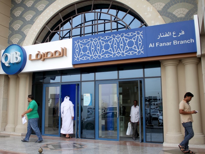 Customers leave one of the branches of Qatar Islamic Bank in Doha April 13, 2016. REUTERS/Naseem Zeitoon