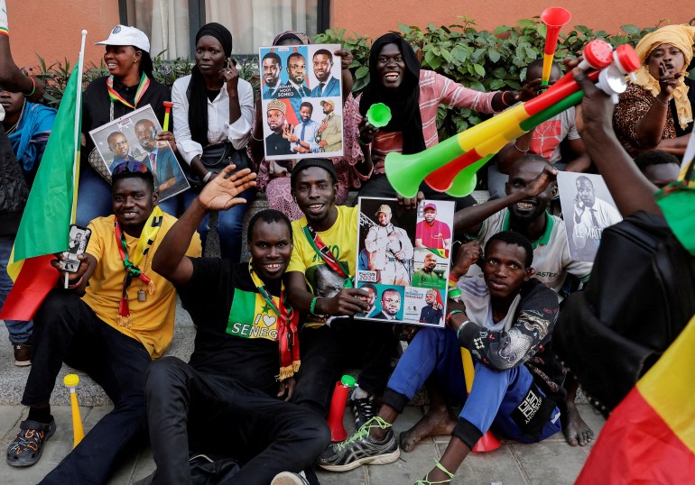 FILE PHOTO: Supporters cheer as Senegalese opposition leader Ousmane Sonko holds a joint press conference with the presidential candidate he is backing in the March 24 election, Bassirou Diomaye Faye, a day after they were released from prison, in Dakar, Senegal March 15, 2024. REUTERS/Zohra Bensemra/File Photo