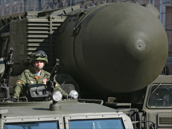 epa04194623 A Russian soldier sits on military vehicle in front of a Russian strategic ballistic missile Topol-M launching vehicle on Tverskaya street during a general rehearsal for a military parade in Moscow, Russia, 07 May 2014. The parade will take place on the Red Square on 09 May to commemorate the victory of the Soviet Union's Red Army over Nazi-Germany in WWII. EPA/SERGEI ILNITSKY