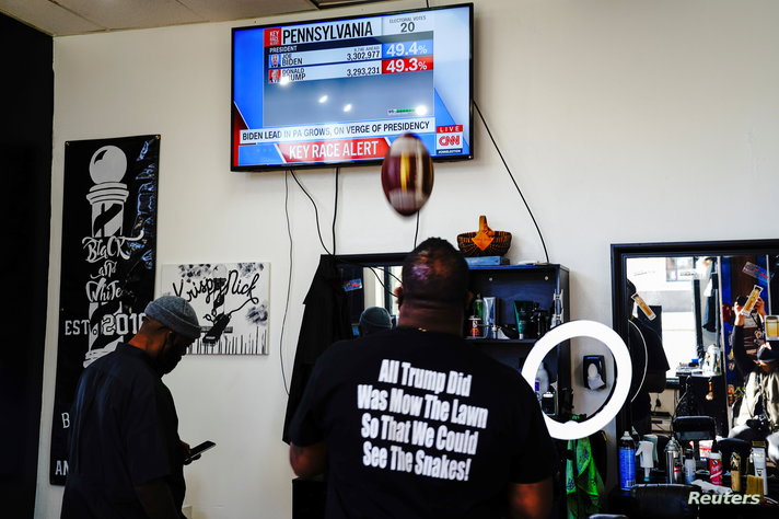 Barbers Adrian Ware and Nate Gaines, supporters of Democratic presidential candidate Joe Biden and his running mate Senator…