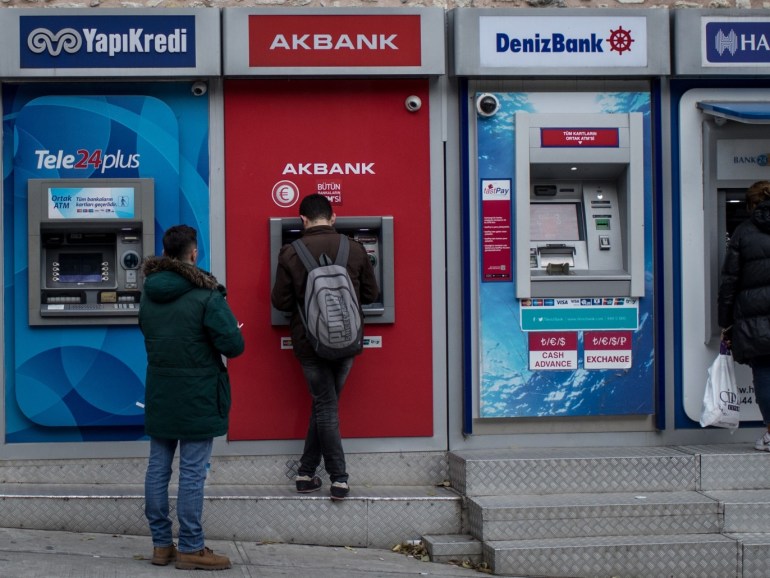 ISTANBUL, TURKEY - DECEMBER 01: People use Turkish bank ATM machines on December 1, 2017 in Istanbul, Turkey. The trial of Mr. Reza Zarrab, an Iranian-Turk who ran a foreign exchange and gold dealership continues in New York. In recent days testimony Mr. Zarrab implicated a number of Turkish Banks as well as high ranking government officials. Mr. Zarrab is accused of managing a billion-dollar scheme to smuggle gold for Iranian oil and conspiring to violate United States