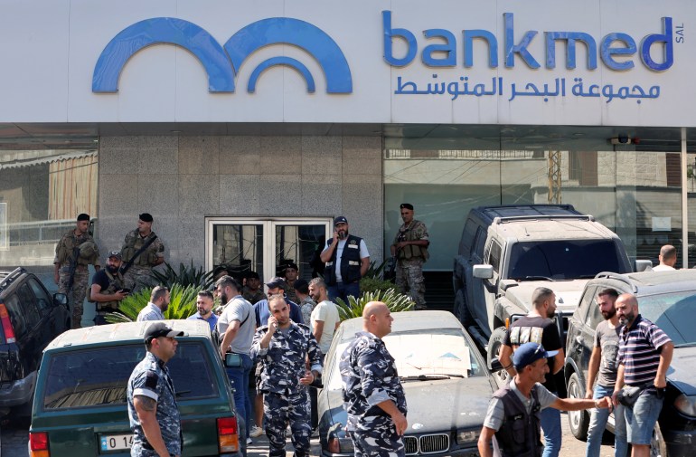 Members of police and army stand guard outside a Bankmed branch, in town of Chehime, Lebanon September 16, 2022. REUTERS/Aziz Taher