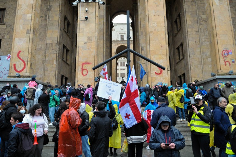 TBILISI, GEORGIA - MAY 14: Demonstrators in front of the Georgian Parliament building, trying to enter the parliament on Rustaveli Avenue, while protesting against the approval of the "Foreign Agent Bill" on May 14, 2024 in Tbilisi, Georgia. The bill, which says media, NGO's and other non-profits must register as "pursuing the interests of a foreign power" if more than 20 percent of their funding comes from abroad, was passed through Georgian Parliament today. (Photo by Nicolo Vincenzo Malvestuto/Getty Images)