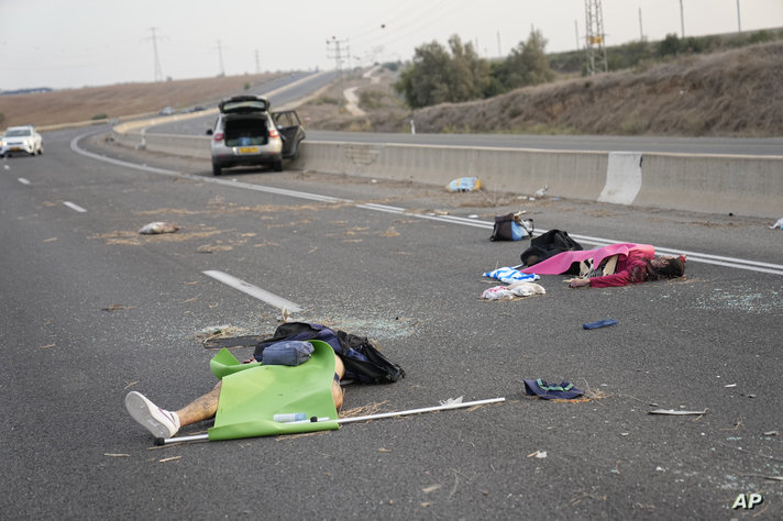 FILE - Israelis killed by Hamas militants lie on the road near Sderot, Israel, Oct. 7, 2023. Some allege the accounts of sexual…