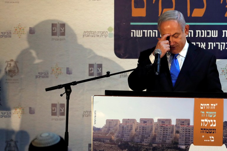 Israeli Prime Minister Benjamin Netanyahu gestures as he speaks during an event inaugurating a new neighborhood in Kiryat Arba, a Jewish settlement in Hebron in the Israeli-occupied West Bank