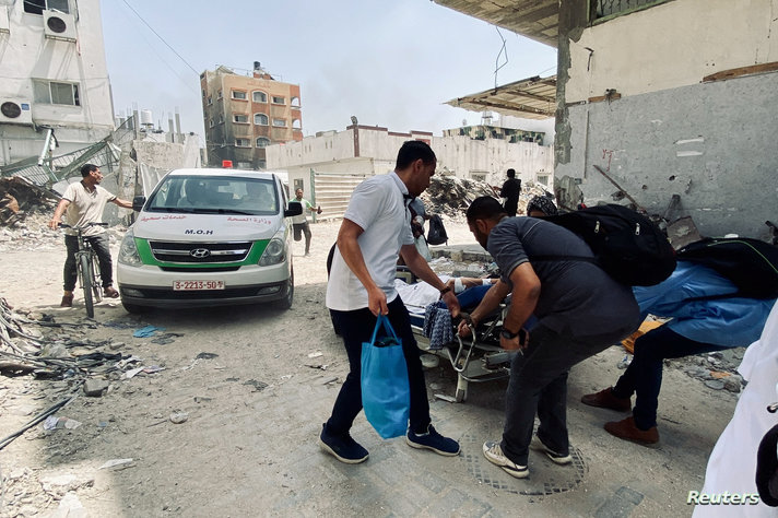 Palestinians evacuate Kamal Adwan hospital following an Israeli strike, in Beit Lahia