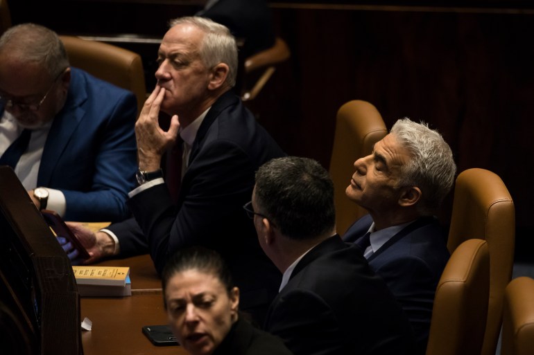 JERUSALEM, ISRAEL - DECEMBER 29: Israeli Prime Minister Yair Lapid and Israeli Minister of Defense Benny Gantz react at the Israeli parliament during a new government sworn in discussion at the Israeli parliament on December 29, 2022 in Jerusalem, Israel. Conservative Benjamin Netanyahu and a bloc of nationalist and religious parties won a clear election victory last month and will be sworn in as government to the Knesset today. This completes Netenyahu's political comeback with a record sixth term in office. (Photo by Amir Levy/Getty Images)