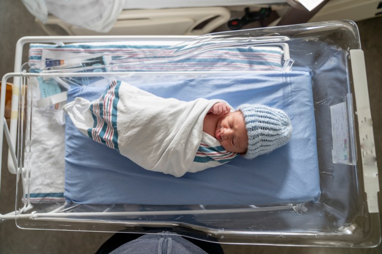 Newborn baby girl and mother in the hospital.