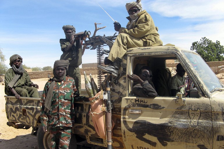 United Front for Change (FUC) fighters patrol 13 January 2007 in Guereda, where the former rebels now ensure security following a peace agreement between the Chadian governement and FUC leader Mahamat Nour in December 2006 in Tripoli. Washington's special envoy to Darfur, Andrew Natsios, said 20 January 2007 that a "quiet war" was underway between Chad and Sudan as leaders in both countries quietly support rebel activities across their borders. AFP PHOTO/SONIA ROLLEY (Photo by SONIA ROLLEY / AFP)