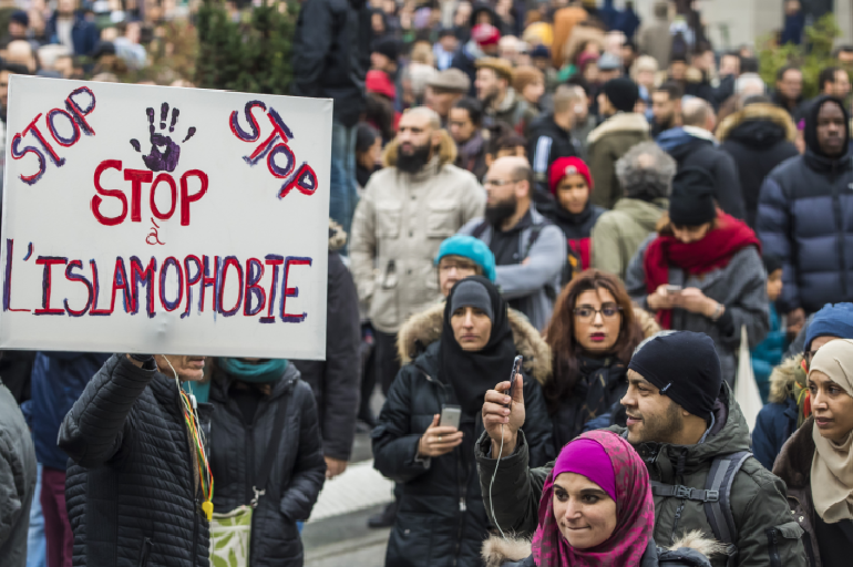 epa07986571 A protester holds a poster reading 'Stop to Islamophobia', as People and members of anti-racism associations gather to protest against Islamophobia at the Gare du Nord in Paris, France, 10 November 2019. Protesters gathered to protest...