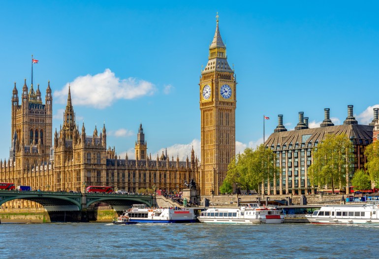 Big Ben tower of Houses of Parliament and Westminster pier, London, UK