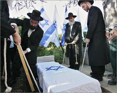 AFPIsraeli Orthodox Jews lower a coffin with the remains of Stephen Theodore Norman, grandson of Theodor Herzl, founder of the Zionist Movement,