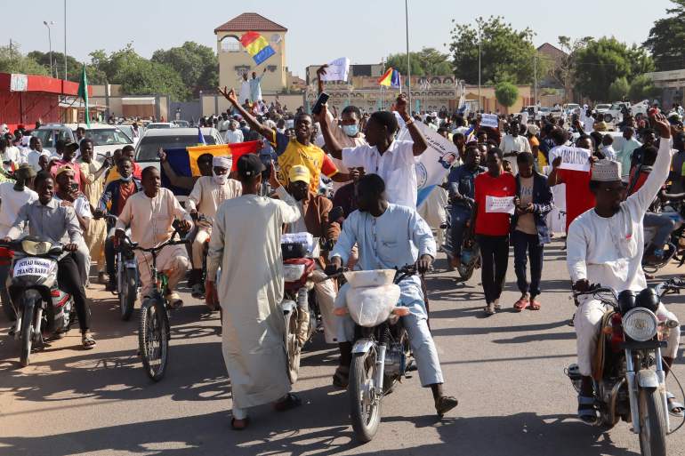 Protesters march during an anti-France demonstration in N'djamena on December 6, 2024. Protesters gathered in the capital N'djamena to show their support to the government's decision to expel French troops from Chad. (Photo by Denis SASSOU GUEIPEUR / AFP)