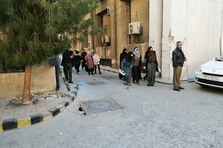 من أمام مدخل العيادات في مستشفى المجتهد مرضى يراجعون بشكل طبيعيع، الجزيرة نت