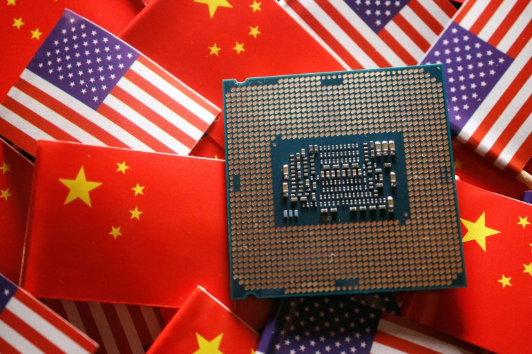 A central processing unit (CPU) semiconductor chip is displayed among flags of China and U.S., in this illustration picture taken February 17, 2023. REUTERS