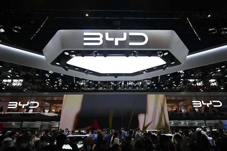 People visit the BYD stand at the Beijing Auto Show on April 29, 2024. (Photo by Pedro PARDO / AFP)