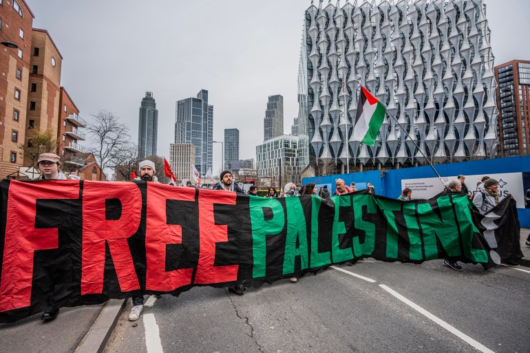 LONDON, UNITED KINGDOM - 2025/02/15: Demonstrator hold a banner during the rally. Thousands of pro-Palestinian supporters marched to the US embassy to protest against President Donald Trump's proposal for the United States to consider taking ownership of the Gaza Strip. (Photo by Lab Ky Mo/SOPA Images/LightRocket via Getty Images)