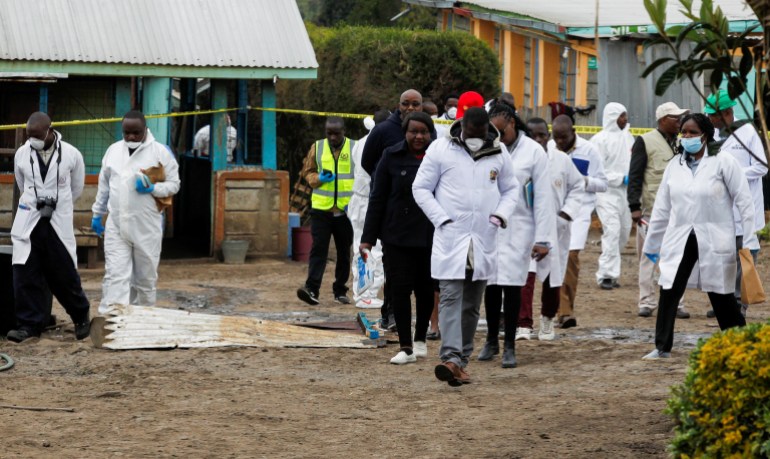 A forensic team from the Directorate of Criminal Investigations inspect the Hillside Endarasha Academy, following a fatal fire that killed and injured several pupils, in Kieni, Nyeri County, Kenya, September 6, 2024. REUTERS/Monicah Mwangi