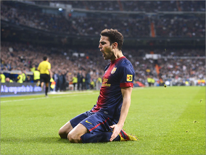 Barcelona's midfielder Cesc Fabregas celebrates after scoring during the Spanish Copa del Rey (King's Cup) semi-final first leg football match Real Madrid CF vs FC Barcelona at the Santiago Bernabeu stadium in Madrid on January 30, 2013. AFP PHOTO / PIERRE-PHILIPPE MARCOU